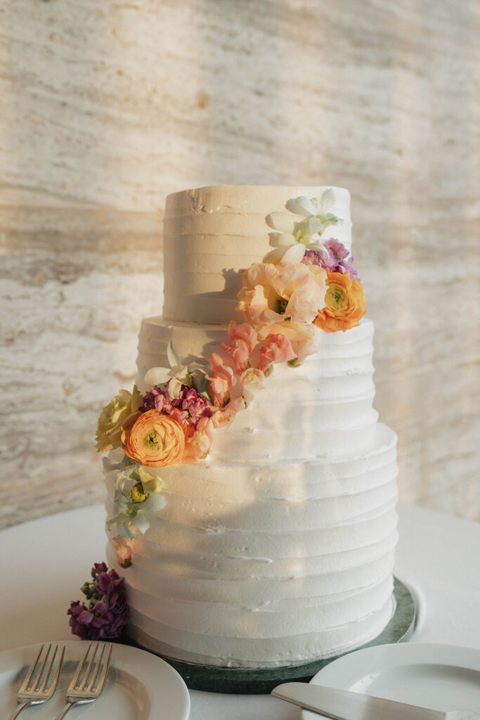 white wedding cake with pastel florals