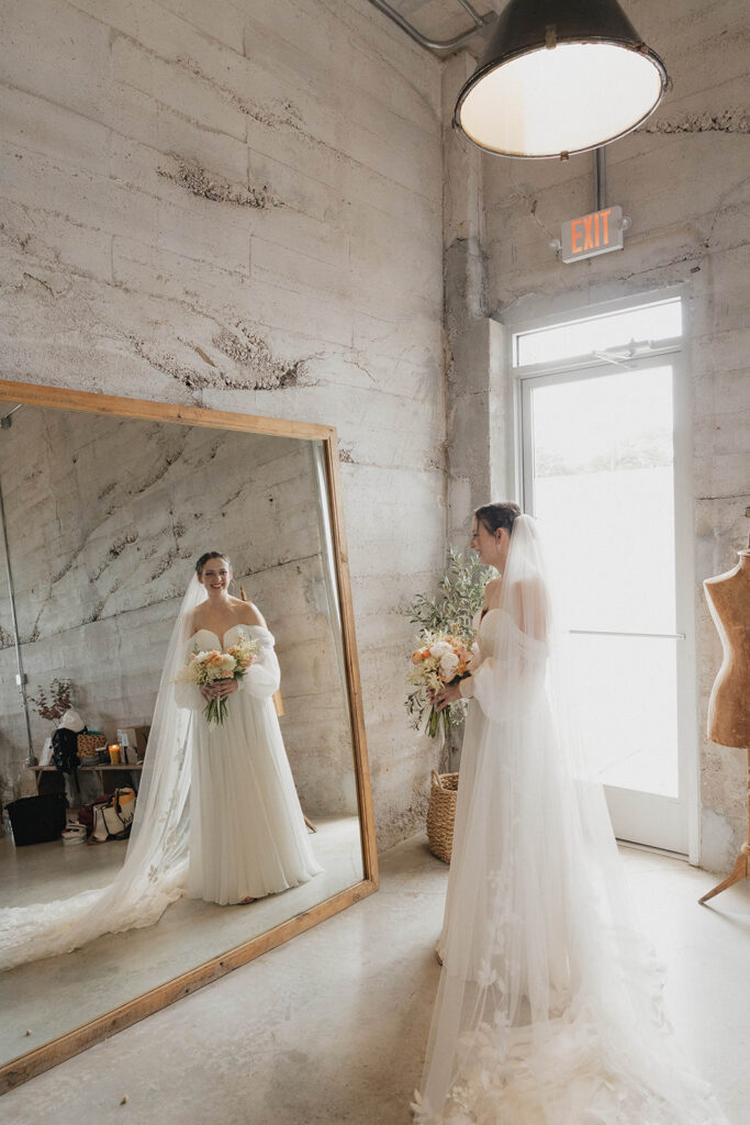 bride looking into a tall mirror