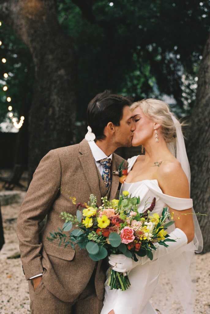 bride and groom kissing on film