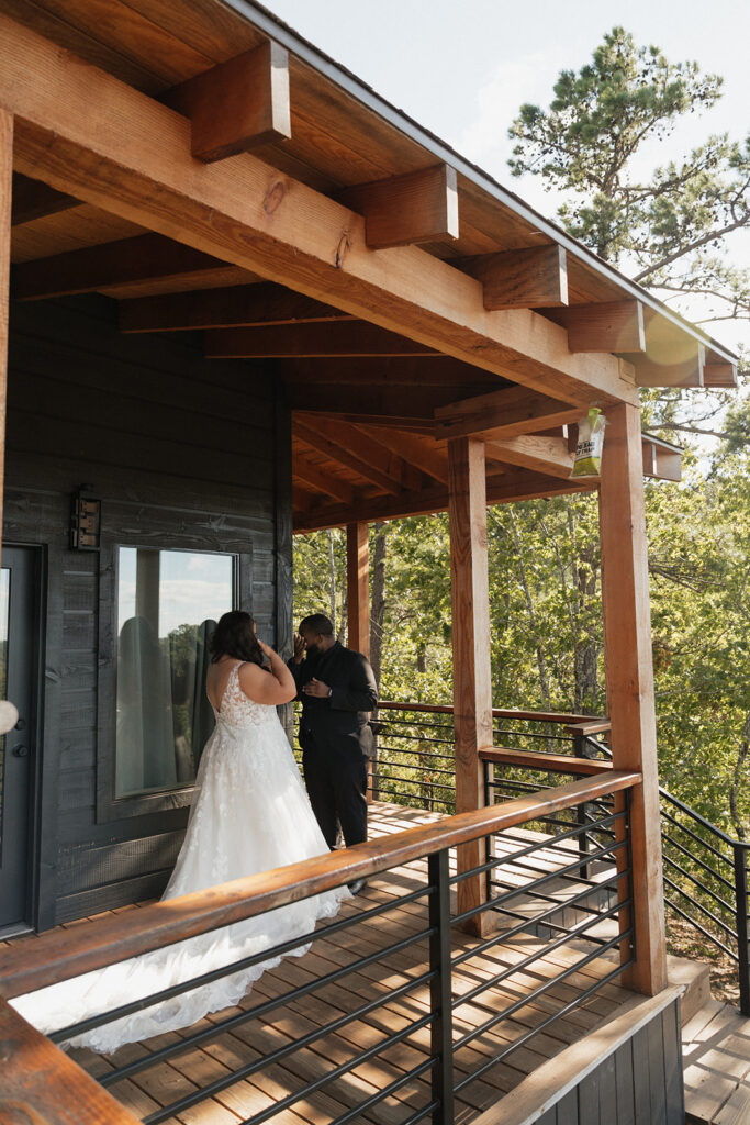 The bride and groom sharing a special moment during their Airbnb elopement surrounded by pine forests in Broken Bow, Oklahoma.