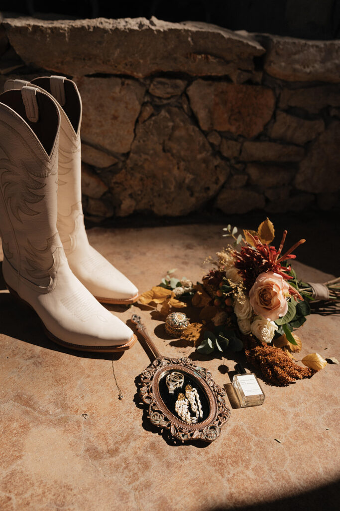 close-up of the bride's stylish boots, adding a touch of western charm to her wedding ensemble at the classy western wedding.